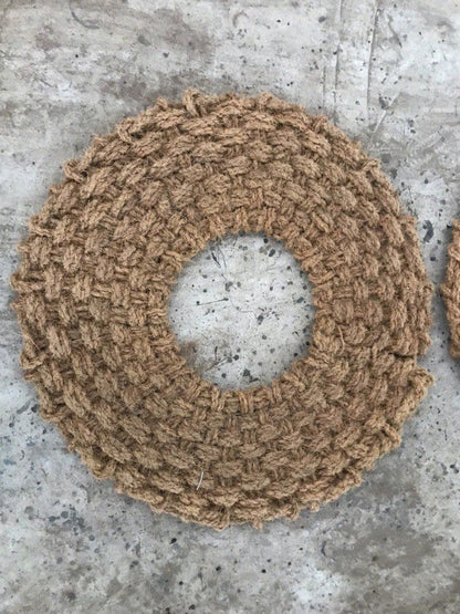 Round woven mulch mat from coconut fiber on a concrete surface